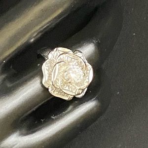 Silver tone flower ring with rhinestone center